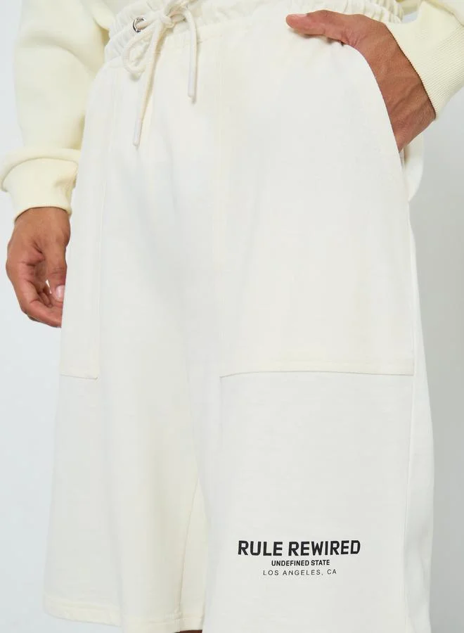 Styli Men Off White Slogan Oversized Shorts